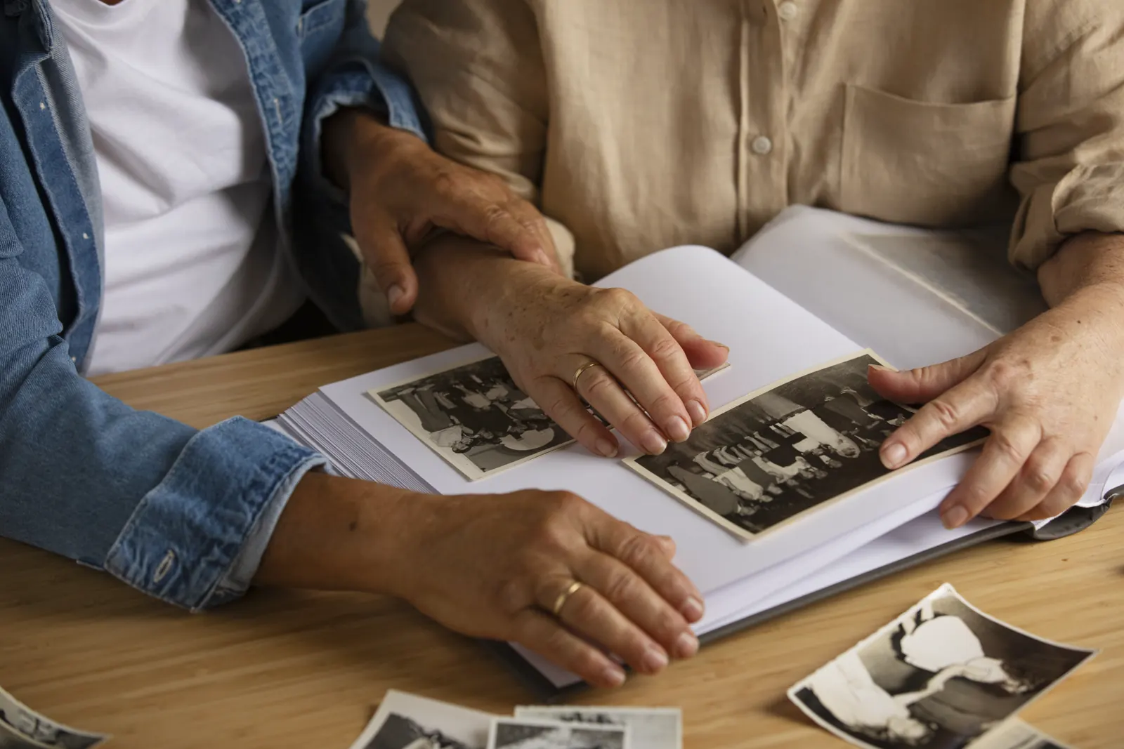 Hands turning the pages of an old photo album